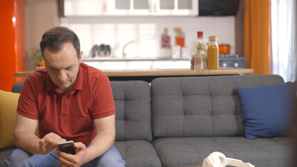 The young man sitting in his seat alone at home. Portrait of thoughtful young man.