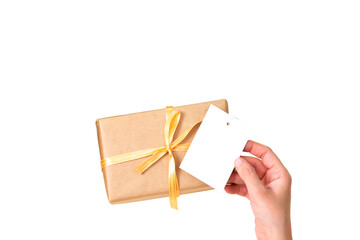gift box with hand holding a black card or tag isolated on white background