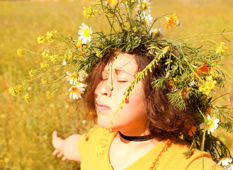 Girl in a wreath of flowers.