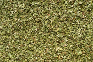 Fotobehang Pile of dried green oregano texture or background. © Kuzmick