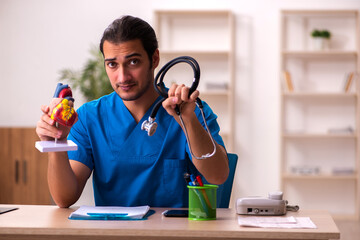 Young male doctor cardiologist working in the clinic