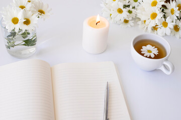 Mockup white notebook with spring white flowers on a white background