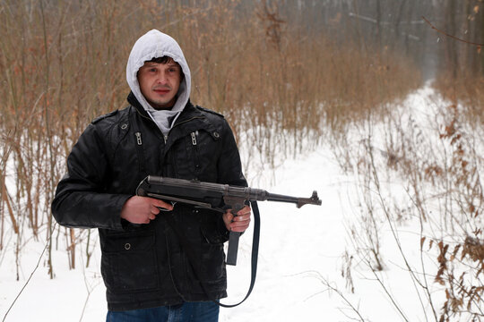 Man with German machine gun in winter forest