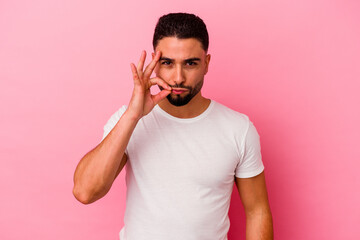 Young mixed race man isolated on pink background