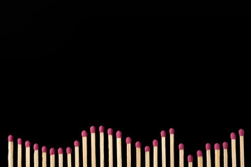 Long chart made of many matches on the black background. Concept of economy, statistics, development.