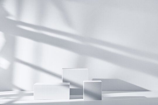 Background for product presentation with shadows and light. Empty podiums. Mockup.