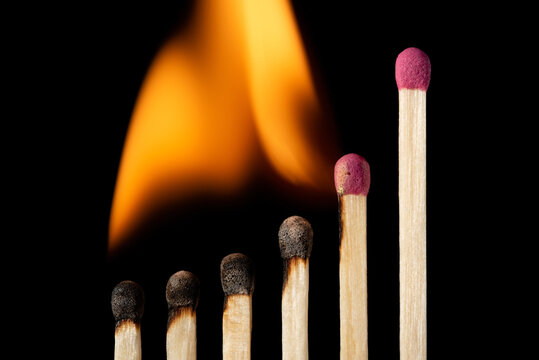 Small upcoming business chart made of matches. Igniting matches in the positive chart, development concept