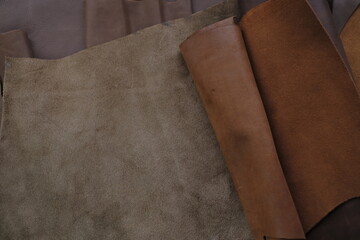 Leather brown pieces and rolls.Leatherworking. Genuine leather piece set of brown...