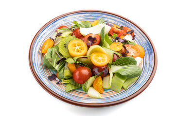Vegetarian salad of pac choi cabbage, kiwi, tomatoes, kumquat, microgreen sprouts isolated on white background. Side view.
