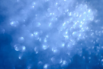 Abstract blurred blue background with glowing bokeh. Sunrays and air bubbles in deep sea