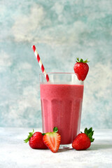 Delicious strawberry smoothie in a tall glass.