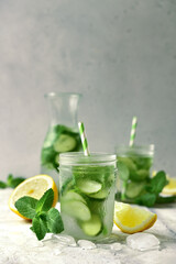 Delicious cold summer lemonade with cucumber and mint in a mason jars.