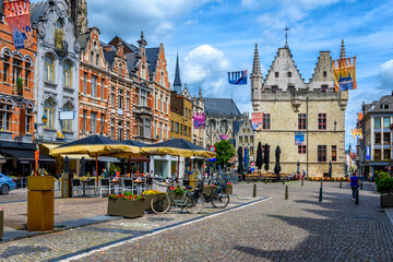 Old street with tables of cafe in Mechelen, Belgium. Mechelen is a city and municipality in the province of Antwerp, Flanders, Belgium. - obrazy, fototapety, plakaty