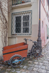 Fototapeta na wymiar Paris, France - 02 26 2021: Montmartre district. A tricycle parked along a wall