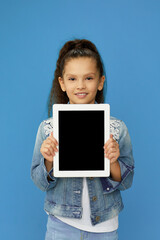 cute little child girl shows empty tablet