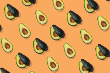 Avocado trendy  pattern on orange  background, Top view.
