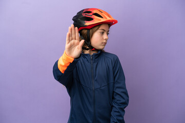 Little caucasian girl isolated on purple background making stop gesture and disappointed