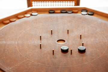 a well used brown crokinole board