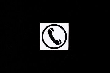 Phone icon, telephone symbol on a black background. Communication concept