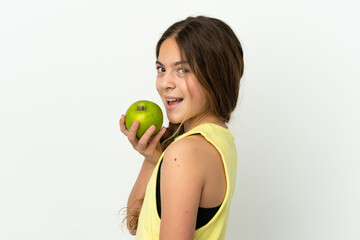 Little caucasian girl isolated on white background eating an apple