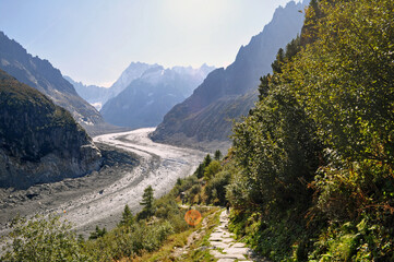 A massive glacier that stretches through a deep valley in the French Alps - Mer de Glace, France