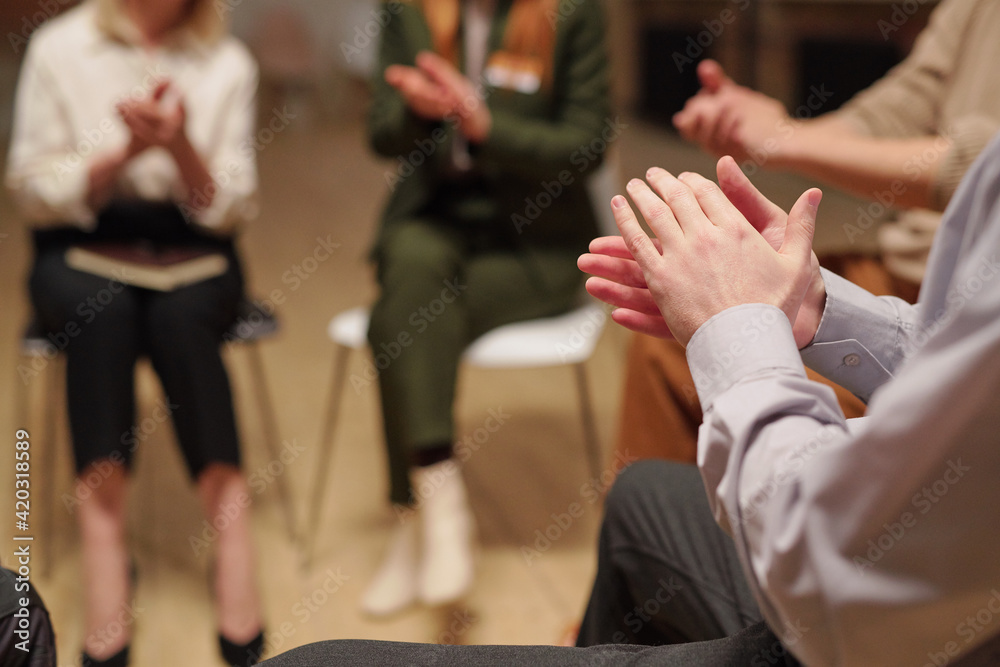 Poster Patients of mental support group clapping hands while sitting in circle during psychological session