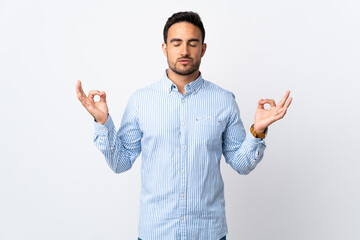 Young handsome man over isolated background in zen pose
