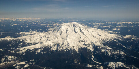 Fototapeta premium View of glorious Mount Rainier from airplane on clear blue sky day.