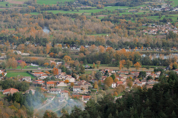 Fototapeta na wymiar Panoramic view over small french village, surrounded by the nature. Autumn panorama. Reflection of trees in the water