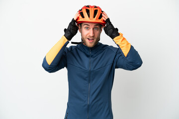 Young cyclist man isolated on white background with surprise expression