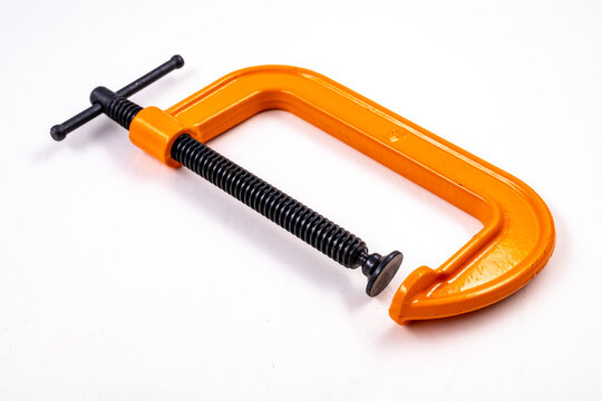 Carpenter's clamp used in a carpentry shop. Metal joinery accessories.