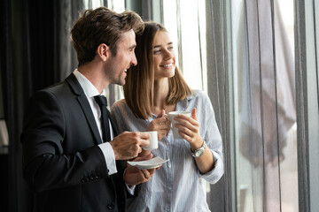 Businesswoman with male colleague discussing. Businessman and businesswomen drinking coffee