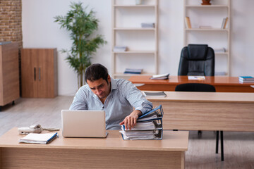 Young male employee unhappy with excessive work