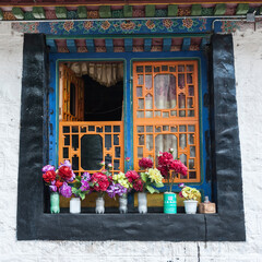 Fototapeta na wymiar NYETANG, TIBET, CHINA - AUGUST, 16 2018: Window of the Monastery of Drolma Lhakhang (Nyetang Temple), Nyetang, Tibet, China 