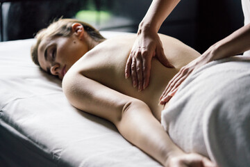 Obraz premium Young beautiful woman having massage in spa salon