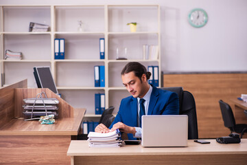 Young male employee working in the office