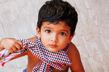 three year old indian baby boy in close up looking