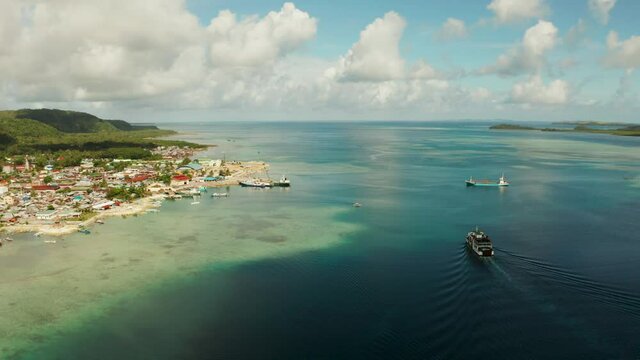 Freight ships and ferries in the bay, top view. Dapa Ferry Terminal. Siargao, Philippines.