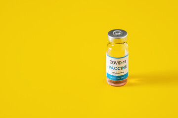 Covid-19 vaccine in sealed glass vial for vaccination, immunization and treatment coronavirus infection on yellow background. Copy space for text