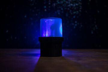 Police car blue and red round vintage siren in dark. Rotating retro style police siren in dark.