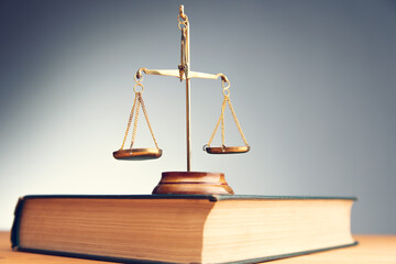 scales of justice on law book