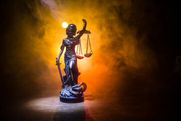 Obraz na płótnie Canvas Law concept. Miniature colorful artwork decoration with fog and backlight. The Statue of Justice - lady justice or Iustitia Justitia the Roman goddess of Justice. Selective focus