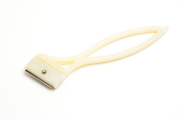 Fruit and vegetable scraper on a white background