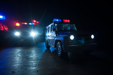 Fototapeta na wymiar Police cars at night. Police car chasing a car at night with fog background. 911 Emergency response police car speeding to scene of crime.