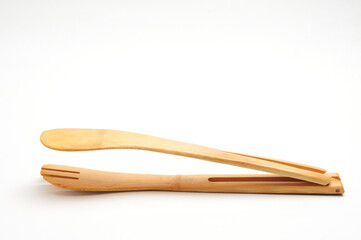 Kitchen tongs for clamping fried hot food on white background