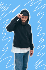 Portrait of handsome bearded hipster guy wearing black blank hoodie and baseball cap with space for...
