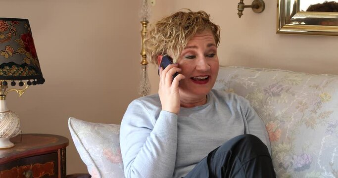 Woman at home talking on mobil phone