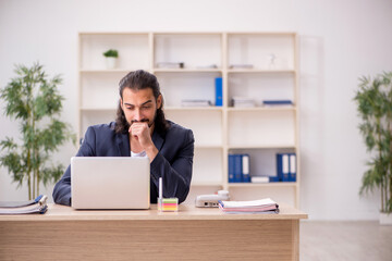 Young male employee working in the office