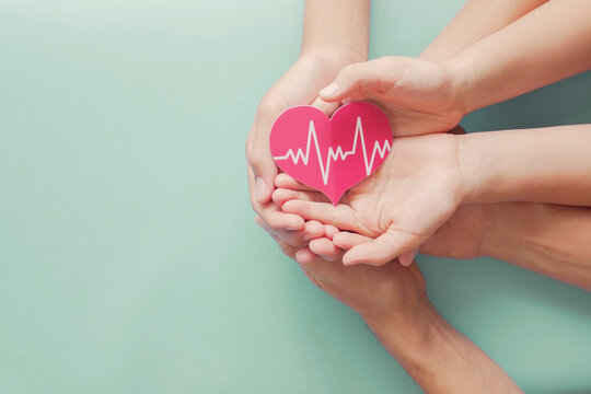 Adult and children hands holding red heart with cardiogram, health care, organ donation, family life insurance, world heart day, world health day, praying concept - Powered by Adobe