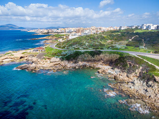 Obraz premium Aerial view of Alghero southern shore under a cloudy sky